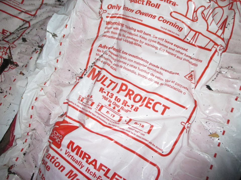 Photo of Owens Corning Miraflex insulation roll packaging with red and white printed text