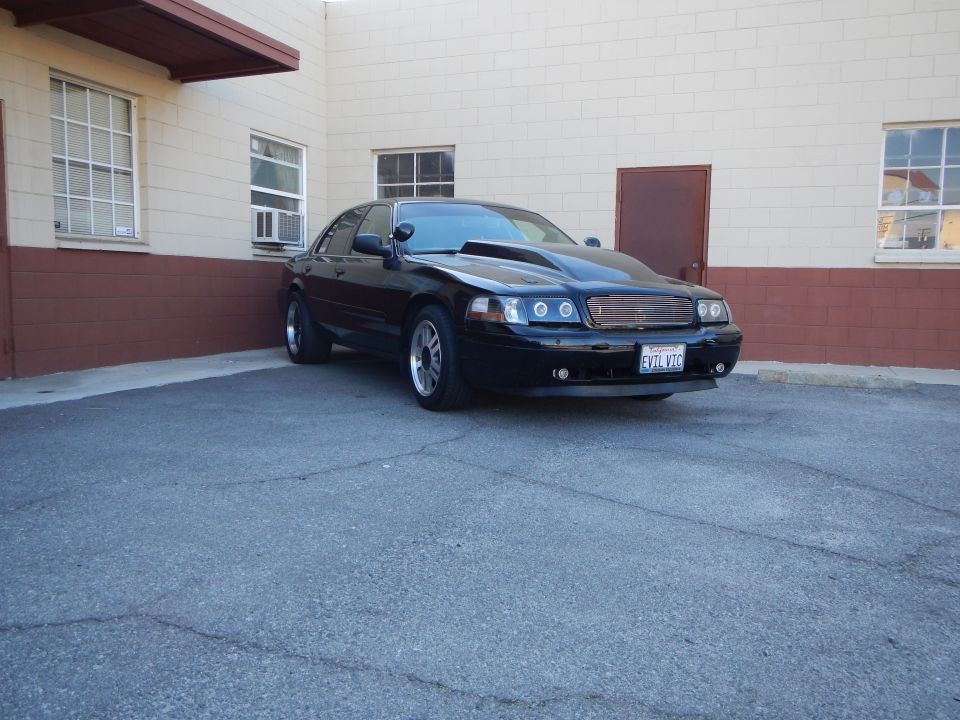 Black Mercury sedan with halo headlights parked outdoors