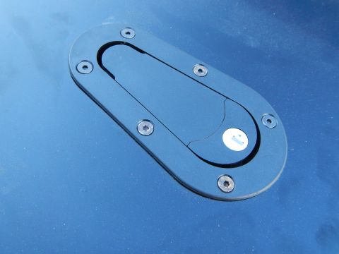 2003 Ford Crown Victoria - black oval flush-mount latch with a recessed pull, installed on a glossy blue painted body panel.