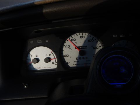 2003 Ford Crown Victoria - vehicle instrument cluster showing a speedometer labeled Marauder, fuel and check-engine gauges, and a glowing blue auxiliary gauge.
