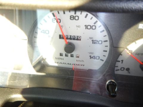2003 Ford Crown Victoria - Close-up of an analog instrument cluster showing a speedometer to 140 mph, an odometer at 109000 miles, and a Marauder script.