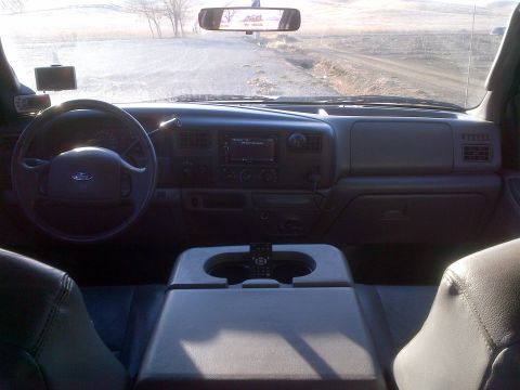 1985 Jeep CJ7 - Dashboard view from the driver's seat of a truck, showing the steering wheel and center console.