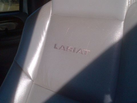 1985 Jeep CJ7 - Embossed Lariat badging is visible on the gray leather seat.