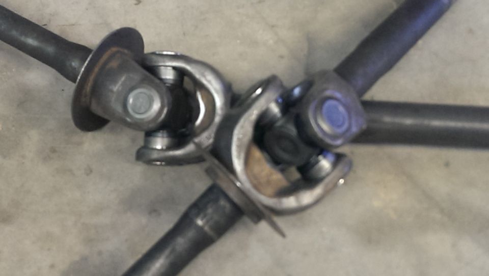 Close-up of three driveshaft universal joints connected