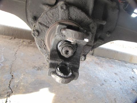 1978 Ford Bronco - Broken and greasy u-joint caps on the axle.