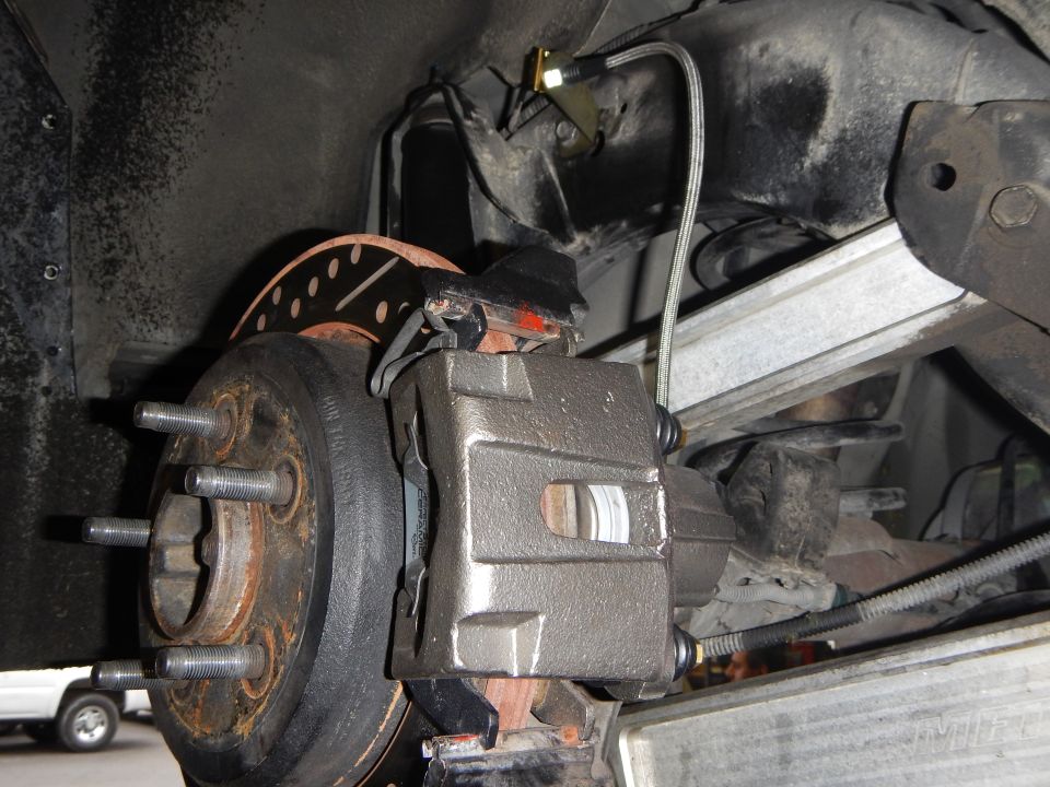 Wheel hub with lug studs, brake caliper and rotor mounted under vehicle