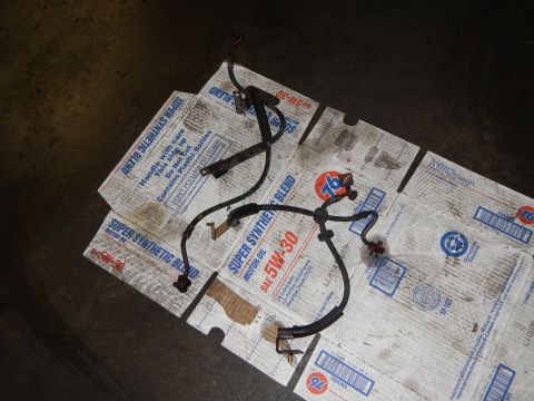 2003 Ford Crown Victoria - Photo of an automotive wiring harness with connectors laid out on cardboard motor-oil flats.