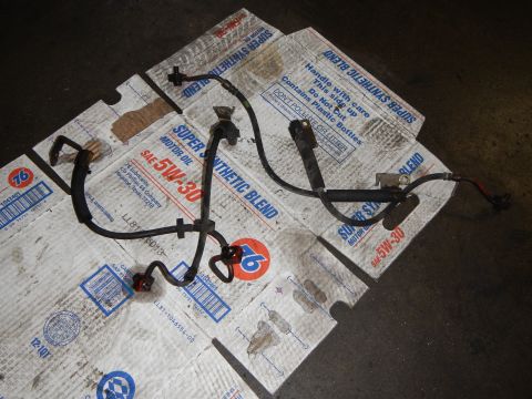 2003 Ford Crown Victoria - Photo of an automotive wiring harness and connectors arranged on cardboard motor-oil boxes.