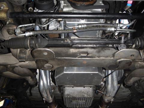 2003 Ford Crown Victoria - Photo of a vehicle underbody showing the steering rack, crossmember and engine oil pan.