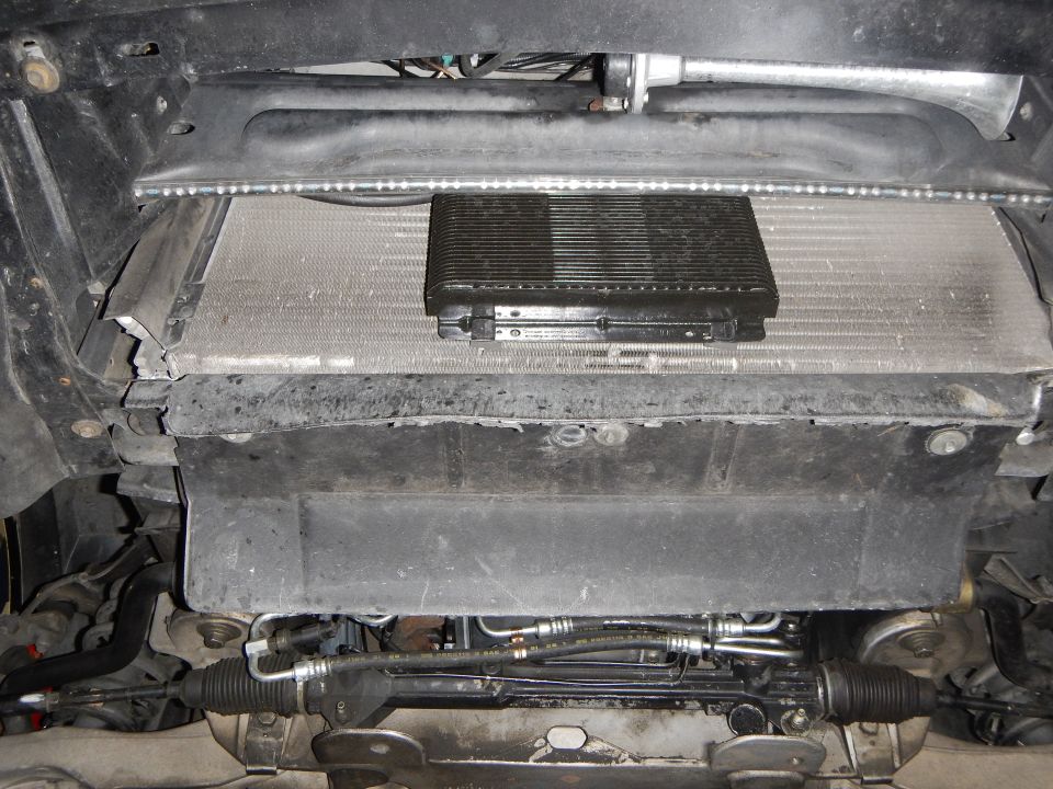 Front of vehicle showing radiator, oil cooler and steering rack from below