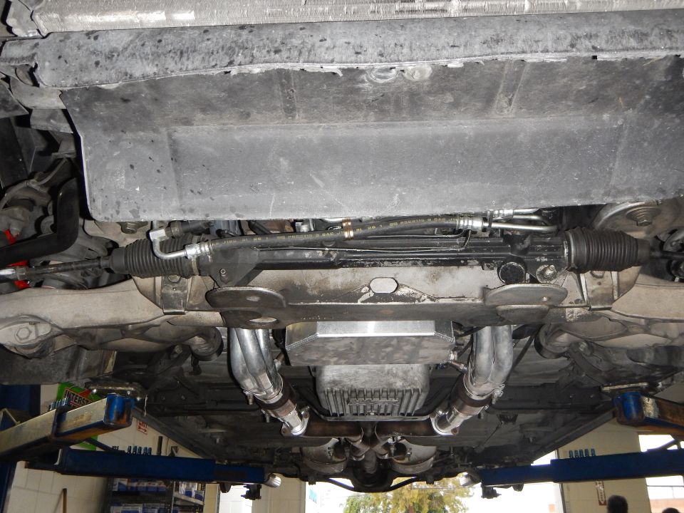Underbody view of steering rack, headers and oil pan on a lift