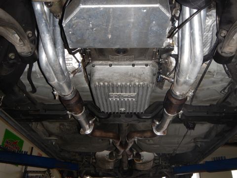 2003 Ford Crown Victoria - Photo of a vehicle underbody showing dual exhaust pipes, oil pan and crossover.
