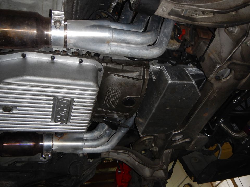 Underbody view of finned aluminum oil pan and exhaust piping