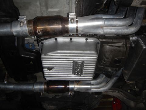 2003 Ford Crown Victoria - Photo of a vehicle underbody showing a catalytic converter, finned oil pan and exhaust pipes.