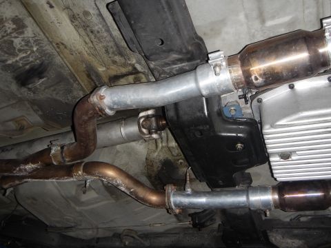 2003 Ford Crown Victoria - Photo of a vehicle underbody showing exhaust pipes, catalytic converter and aluminum oil pan.