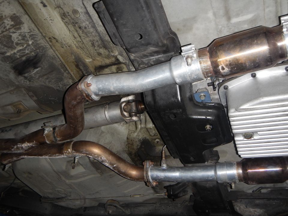 Underbody view of exhaust pipes, catalytic converter and oil pan