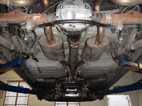 2003 Ford Crown Victoria - Photo of a vehicle rear underbody showing a Drake differential cover, mufflers and exhaust crossover.