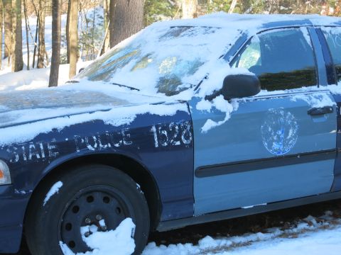 2001 Ford Crown Victoria - Photograph of a snow-covered State Police sedan, not a technical document.