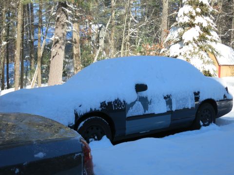 2001 Ford Crown Victoria - Photograph of a snow-covered sedan, not a technical document.