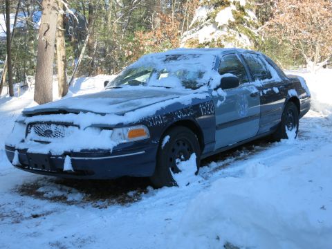 2001 Ford Crown Victoria - Photograph of a snow-covered State Police sedan, not a technical document.