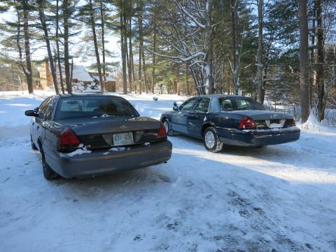 2001 Ford Crown Victoria - Photograph of sedans parked in snow, not a technical document.