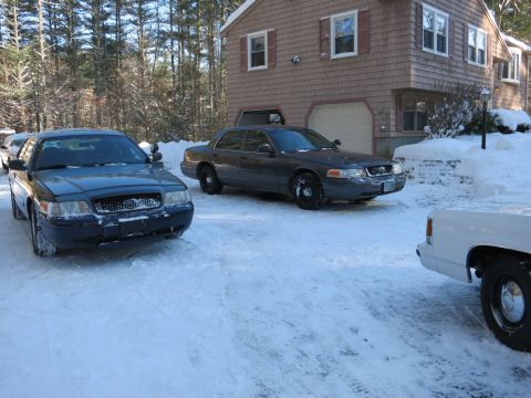 2001 Ford Crown Victoria - Photograph of sedans in a snowy driveway, not a technical document.