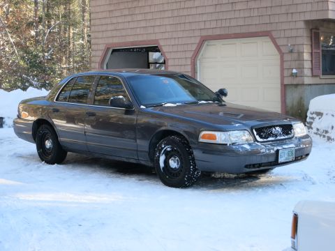 2001 Ford Crown Victoria - Photograph of a gray Ford Crown Victoria in a driveway, not a technical document.
