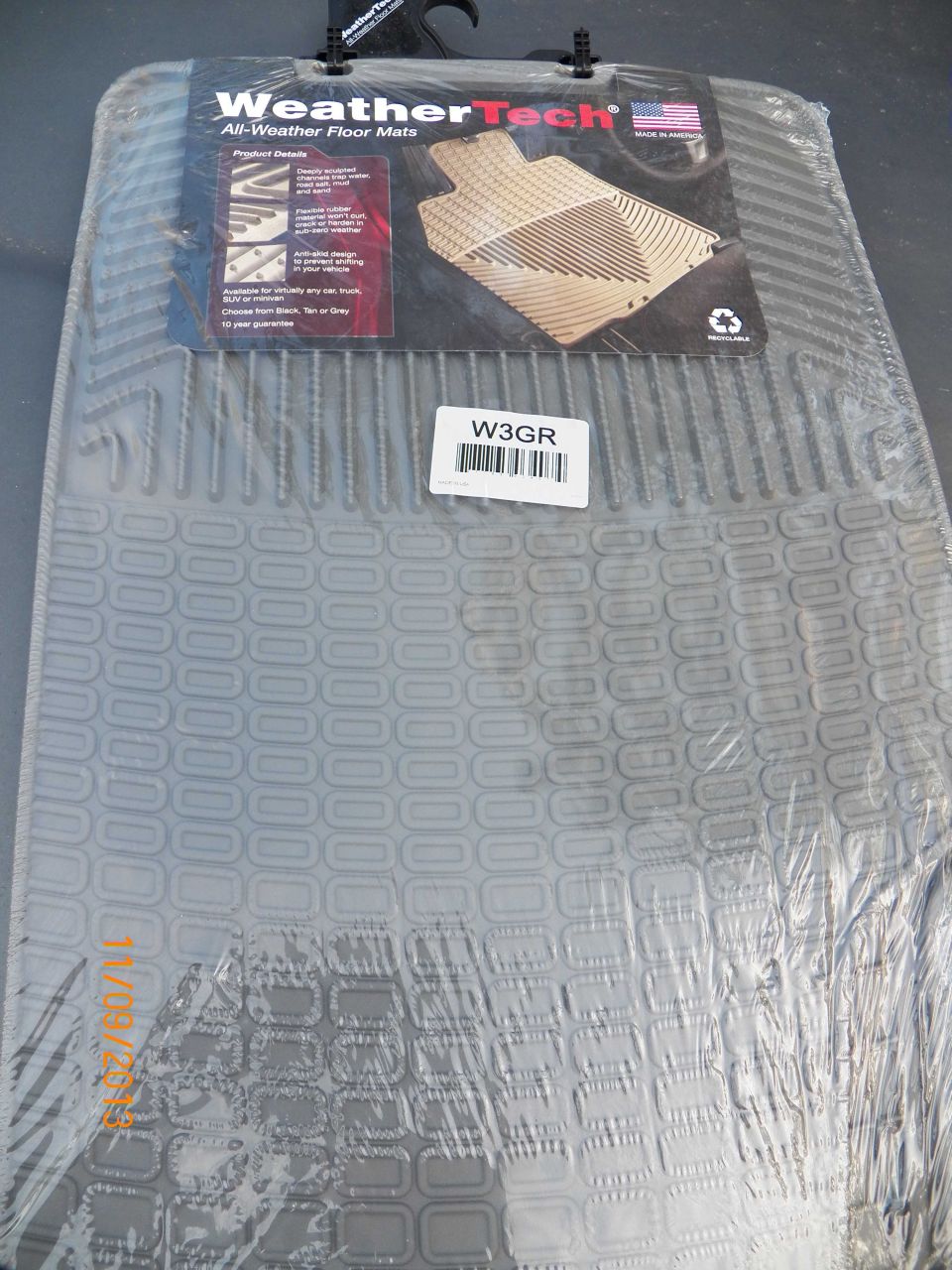 Gray WeatherTech All-Weather Floor Mats in plastic packaging with product label.