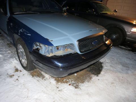 2001 Ford Crown Victoria - Photograph of a Ford Crown Victoria front end with the bumper removed, not a technical document.