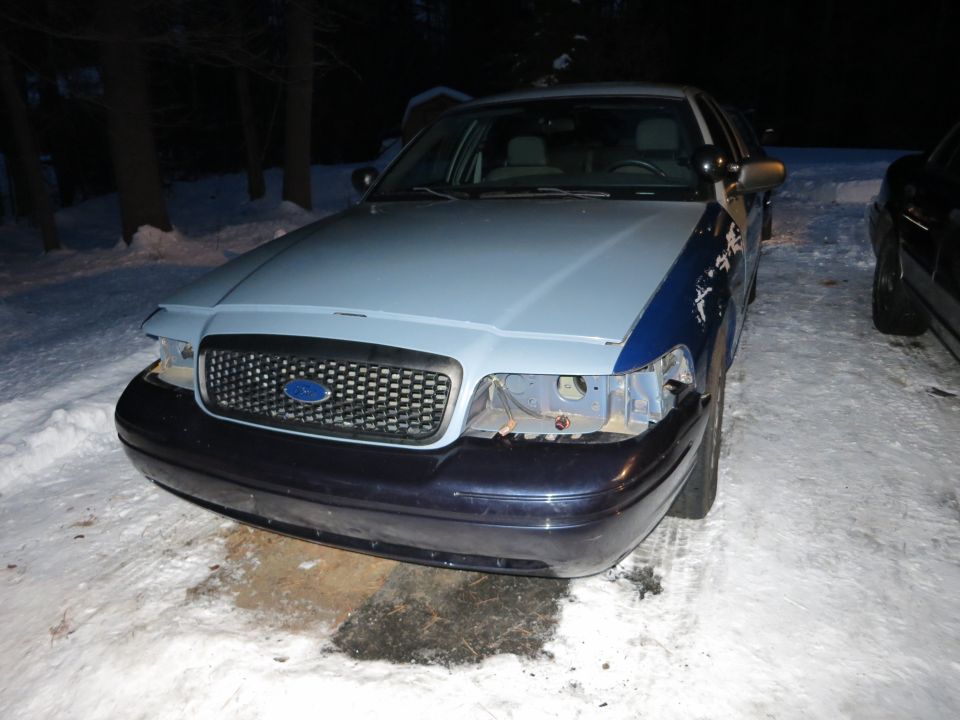 Two-tone Ford Crown Victoria front end at night with bumper work in progress