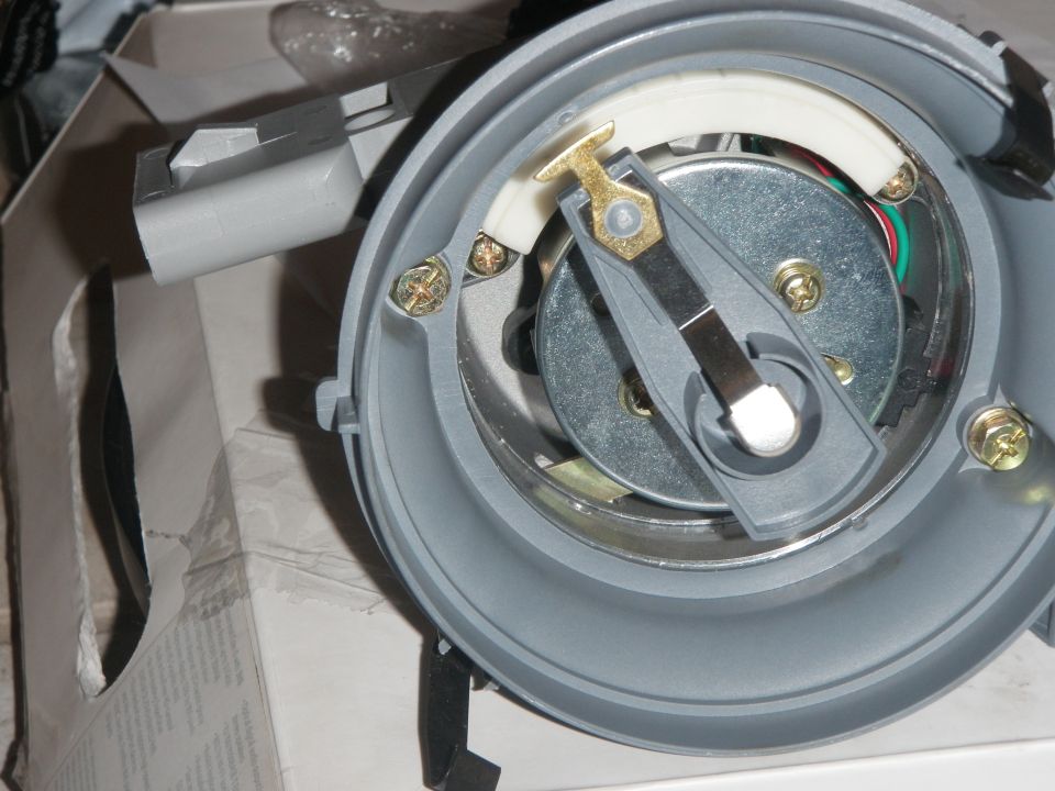 Distributor cap interior with rotor, points, and condenser visible.