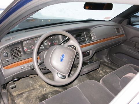 2001 Ford Crown Victoria - Photograph of a Ford Crown Victoria interior dashboard and steering wheel, not a technical document.