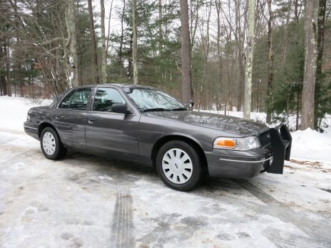 2001 Ford Crown Victoria - Photograph of a gray Ford Crown Victoria with a front push bar in snow, not a technical document.