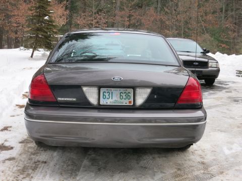 2001 Ford Crown Victoria - Photograph of the rear of a Ford Crown Victoria Police Interceptor parked on snow, not a technical document.