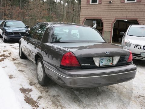 2001 Ford Crown Victoria - Photograph of a Ford Crown Victoria sedan from the rear quarter, not a technical document.