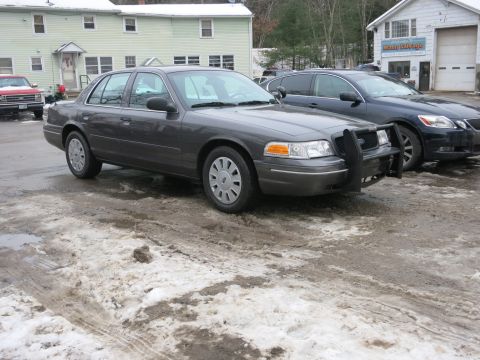 2001 Ford Crown Victoria - Photograph of a Ford Crown Victoria Police Interceptor with push bumper, not a technical document.