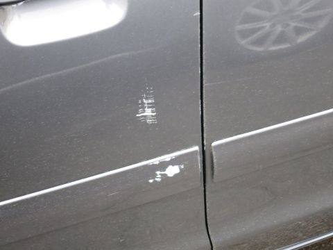 2001 Ford Crown Victoria - Close-up photograph of paint scratches on a vehicle door, not a technical document.