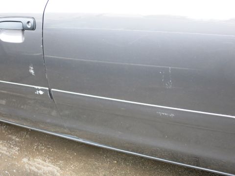 2001 Ford Crown Victoria - Close-up photograph of a vehicle door and rocker panel, not a technical document.