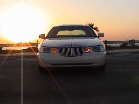 2002 Lincoln Town Car - A white Lincoln Town Car is parked facing the camera during a sunset.