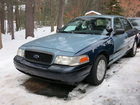 2001 Ford Crown Victoria - Photograph of a blue Ford Crown Victoria from the front quarter, not a technical document.