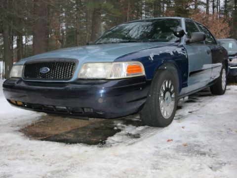 2001 Ford Crown Victoria - Photograph of a blue Ford Crown Victoria from the front quarter, not a technical document.