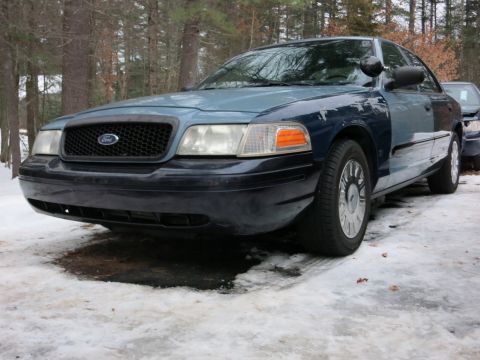 2001 Ford Crown Victoria - Photograph of a blue Ford Crown Victoria from the front quarter, not a technical document.