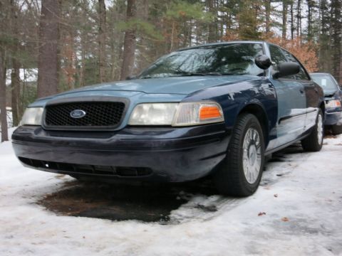 2001 Ford Crown Victoria - Photograph of a blue Ford Crown Victoria from the front quarter, not a technical document.