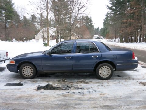 2001 Ford Crown Victoria - Side-profile photograph of a blue Ford Crown Victoria sedan, not a technical document.