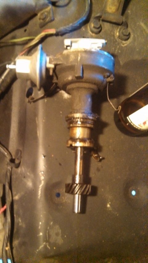 1979 Ford Bronco - A close-up view of a distributor assembly with a gear at the bottom, likely from a 1979 Ford Bronco.