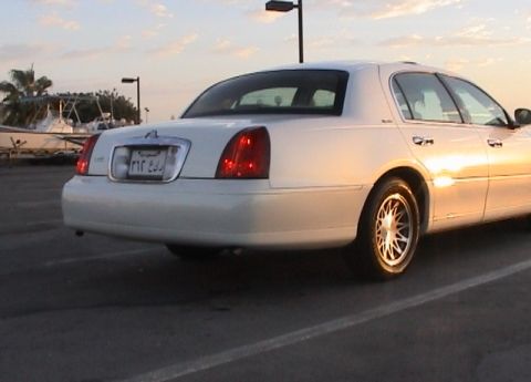 2002 Lincoln Town Car - Rear view of a white 2002 Lincoln Town Car with a license plate Arabic script.