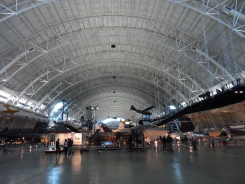 1971 Ford Ranchero - A wide shot of an aviation museum various aircraft under a large, arched roof structure.