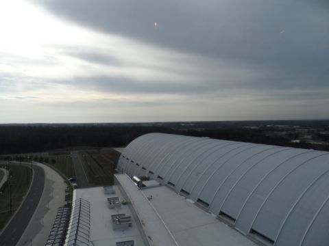 1971 Ford Ranchero - A wide view of a large, modern arched building under a dramatic, overcast sky.