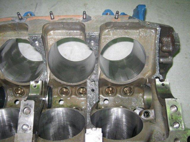 Close-up of engine block cylinders with some wear visible