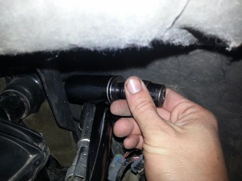 1995 Ford F-150 - A hand holds a socket wrench extension, suggesting a repair or maintenance task is underway within the vehicle's interior.